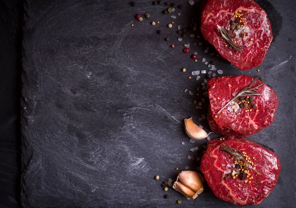 Raw filet mignon steaks with spices — Stock Photo, Image