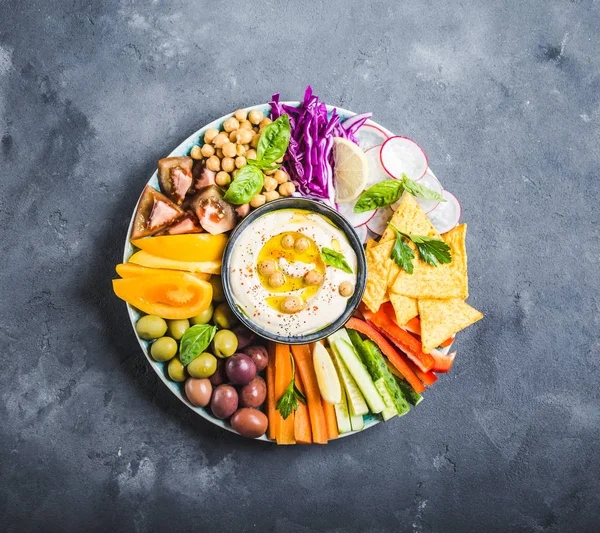 Hummus platter with assorted snacks — Stock Photo, Image