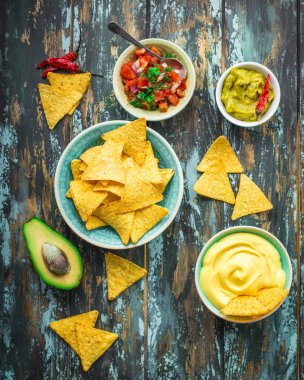 Nachos and assorted dips clipart