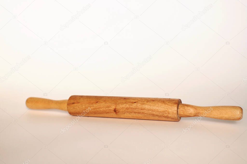Wooden rolling pin on a white background