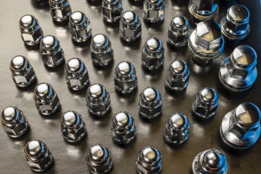 Birçok yeni araba tekerleği fındığı, soyut arkaplanı kapatma