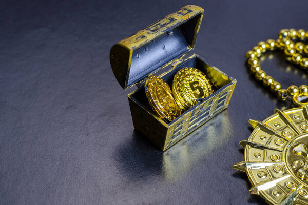 pirate treasure chest, close-up of a pirate gold medallion with necklace