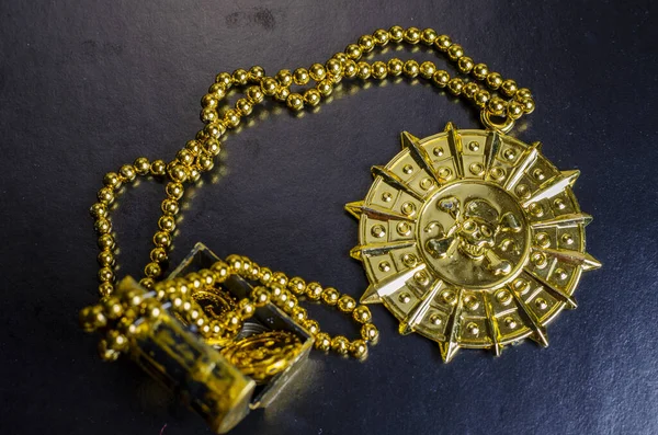 pirate treasure chest, close-up of a pirate gold medallion with necklace