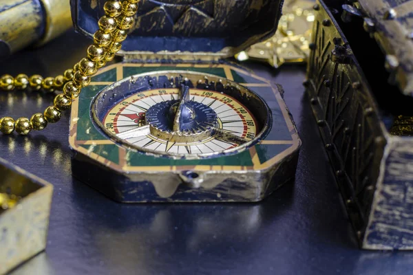 pirate treasure chest, close-up of a gold pirate medallion with a necklace