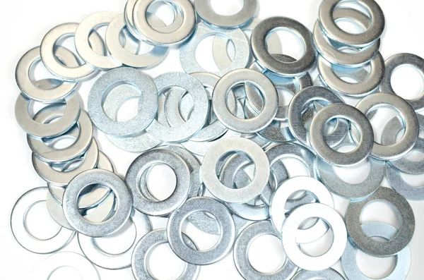 A pile of flat washers on a white background. close-up