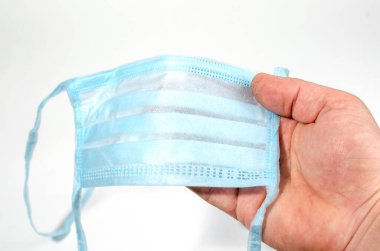 Adamın elinde koruyucu bir maske var. Koronovirüs için endişeleniyor.