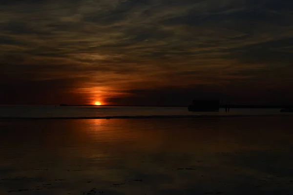 Beautiful orange sunset sky reflection on calm sea