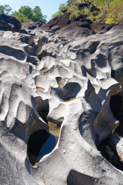 Vale da Lua - a river flowing through lunar landscape of weathered rock clipart