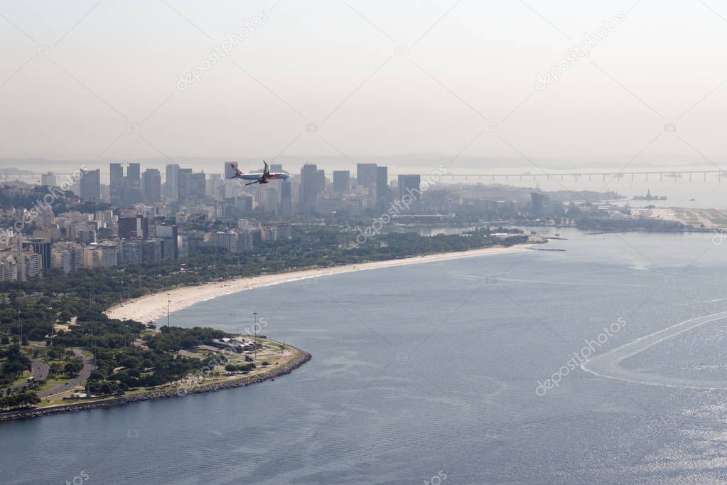 View from Pao de Azucar onto rio de Janeiro. GOL Airlines plane descending on the approach to the Santos Dumont Airport.