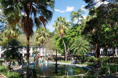 Mariana, Minas Gerais, Brazil (2014). Park with people relaxing by the fountain.