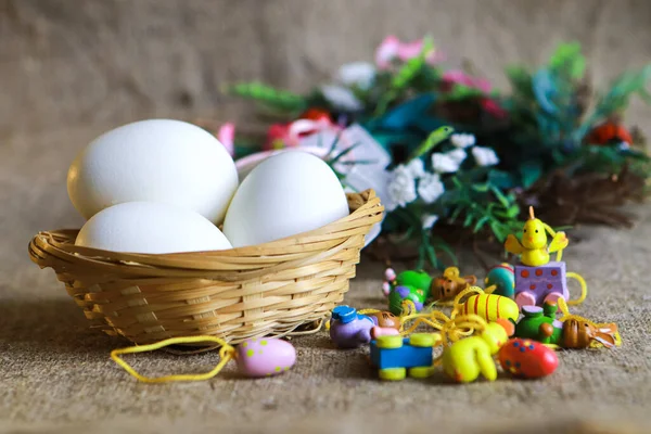 Paskalya yumurtaları ve kahverengi kumaş üzerinde küçük dekoratif yumurtalar.