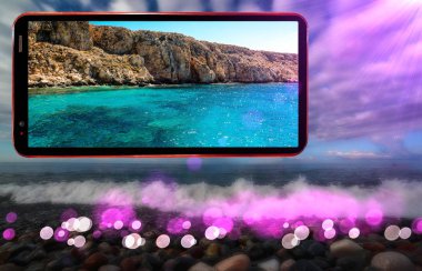 Kıbrıs Rum Kesimi deniz manzaralarını gösteren cep telefonu ekranının kolajı, dalgalı deniz plajının nemli taşlarla bulanık arka planını bulanıklaştırdı