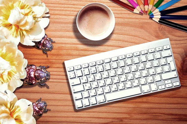 Conceptual view of computer bugs on striped wooden desk with keyboard