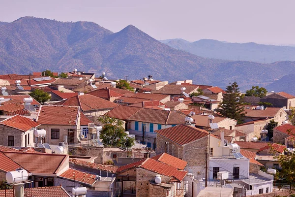 Mountain slopes and red roof village of sunny Cyprus