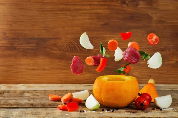 Pumpkin and flying ingredients for cook beef stew in pumpkin