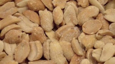 Fried salted peanuts rotates. View from above.