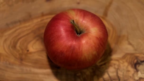 Cortar una manzana con un cuchillo en una tabla — Vídeos de Stock