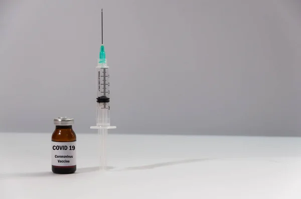 Coronavirus vaccine. Vaccine and syringe injection on white background. It use for prevention, immunization and treatment from coronavirus infection COVID 19. Cure for infectious disease concept. End coronavirus concept.