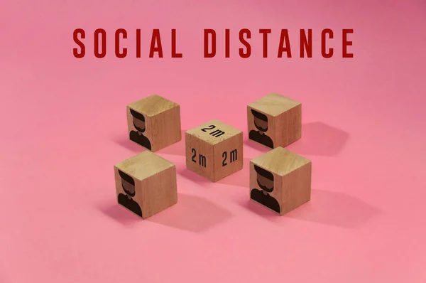 Social distance, people practice social distancing to protect from COVID-19 coronavirus. Social distancing sign with cubes apart from each other respecting correct distance. Top view. Respecting space