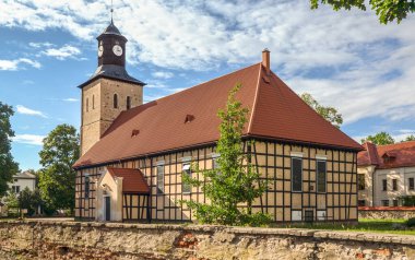 Church of Saint John the Baptist in Pisz from the 17th century (the oldest part - tower). The church, with half-timbered walls, was built in 1737. Masuria, Poland.  clipart