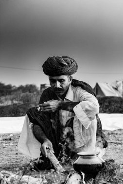 Pushkar, Rajasthan / India - November 2019 : Portrait of rajasthani camel trader in colorful turban and ethnic rajasthani dress at camel fair