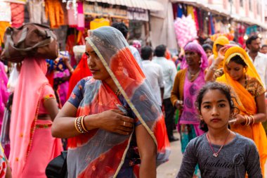Pushkar, Rajasthan / India - November 2019 : Indian young female participating in pushkar fair in regional dress to attract tourists