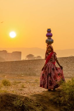 Pushkar, Rajasthan / India - November 2019 : Portrait of young indian woman in traditional rajasthani dressing  with makeup to attract tourist in the fair ground