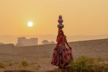 Pushkar, Rajasthan / India - November 2019 : Portrait of young indian woman in traditional rajasthani dressing  with makeup to attract tourist in the fair ground