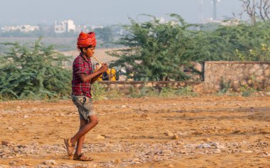 Pushkar, Rajasthan / India - November 2019 : Portrait of rajasthani camel owner/trader in colorful turban and white dress with big mustache participating in camel trading fair