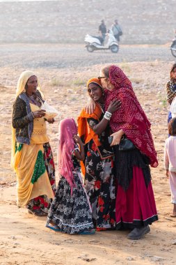 Pushkar, Rajasthan / India - November 2019 : Portrait of young indian woman in traditional rajasthani dressing  with makeup to attract tourist in the fair ground