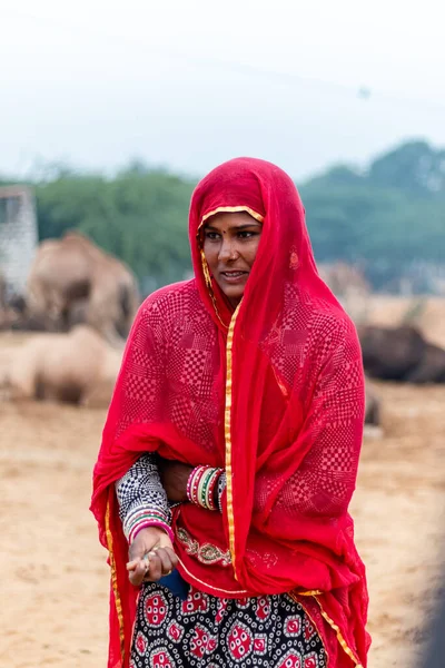 Pushkar, Rajasthan / India - November 2019 : Portrait of young indian woman in traditional rajasthani dressing  with makeup to attract tourist in the fair ground