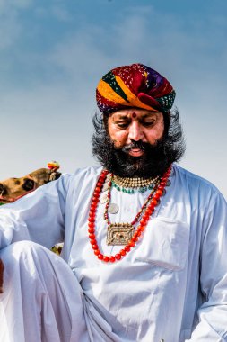 Bikaner, Rajasthan / India - January 2019 : Portrait of rajasthani people  of bikaner in traditional dress and jewelry with long mustache and beard participating in bikaner camel festival
