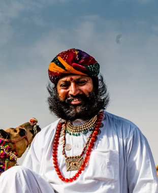 Bikaner, Rajasthan / India - January 2019 : Portrait of rajasthani people  of bikaner in traditional dress and jewelry with long mustache and beard participating in bikaner camel festival
