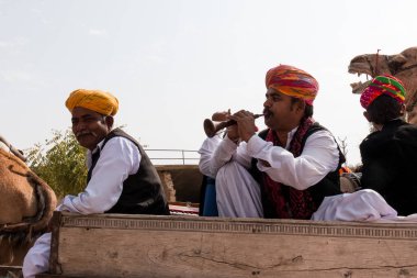 Bikaner, Rajasthan / India - January 2019 : Artist performing folk music in traditional dress and colorful turban at bikaner camel festival