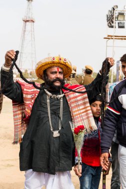 Bikaner, Rajasthan / India - January 2019 : Portrait of rajasthani people  of bikaner in traditional dress and jewelry with long mustache and beard participating in bikaner camel festival