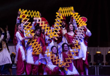 Bikaner, Rajasthan / India - January 2019 : Artists from punjab dance group performing world famous indian folk punjabi bhangra dance at the bikaner camel festival evening
