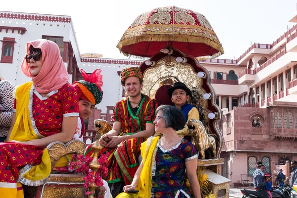 stock image Bikaner, Rajasthan / India - January 2019 : Portrait of foreigner tourists greetings with local people of bikaner and tourists in traditional dress during opening ceremony of camel festival
