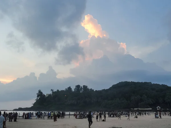 Landscape of Goa beaches with moody sky and tourists