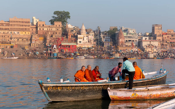 Varanasi, Uttar Pradesh / India - April 2019 :  Indian Buddhist Monk taking the boast ride in River Ganges in Varanasi