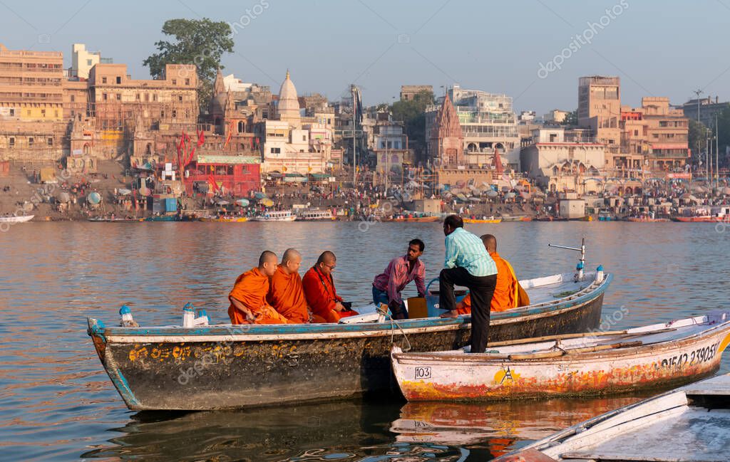 Varanasi, Uttar Pradesh / India - April 2019 :  Indian Buddhist Monk taking the boast ride in River Ganges in Varanasi
