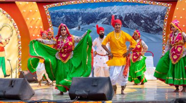 FARIDABAD, HARYANA / INDIA - FEBRUARY 2020 : Young Indian dancers  performing regional/folk dance in colorful dresses clipart