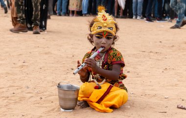 PUSHKAR, RAJASTHAN / INDIA - Kasım 2019: Pushkar Deve Fuarı 'nda Lord Krishna makyajı ve elbise giymiş şirin Hintli türü