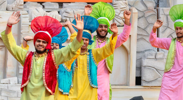 Sikh people performing  Punjabi Bhangra dance to celebrate festivals in Surajkund Craft Fair, Faridabad, Haryana, India