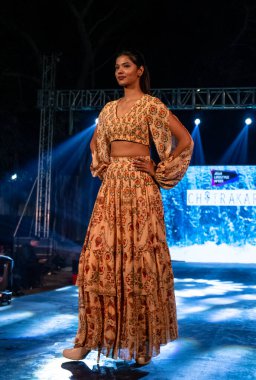 Aralık 2020 'de Yeni Delhi, Hindistan' daki moda fuarında bir model modacı etnik bahar koleksiyonu giyerek podyumda yürüyor.