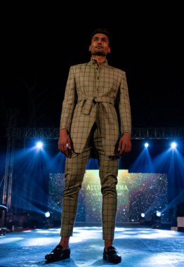 Aralık 2020 'de Yeni Delhi, Hindistan' daki moda fuarında bir model modacı etnik bahar koleksiyonu giyerek podyumda yürüyor.