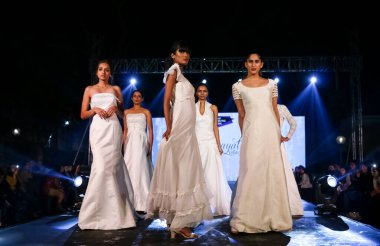 Aralık 2020 'de Yeni Delhi, Hindistan' daki moda fuarında bir model modacı etnik bahar koleksiyonu giyerek podyumda yürüyor.