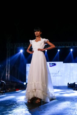 Aralık 2020 'de Yeni Delhi, Hindistan' daki moda fuarında bir model modacı etnik bahar koleksiyonu giyerek podyumda yürüyor.
