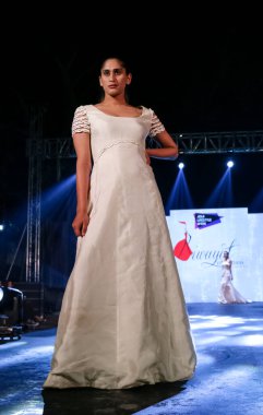 Aralık 2020 'de Yeni Delhi, Hindistan' daki moda fuarında bir model modacı etnik bahar koleksiyonu giyerek podyumda yürüyor.