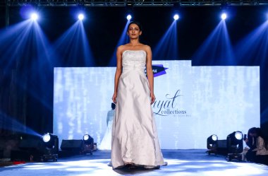 Aralık 2020 'de Yeni Delhi, Hindistan' daki moda fuarında bir model modacı etnik bahar koleksiyonu giyerek podyumda yürüyor.