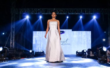Aralık 2020 'de Yeni Delhi, Hindistan' daki moda fuarında bir model modacı etnik bahar koleksiyonu giyerek podyumda yürüyor.